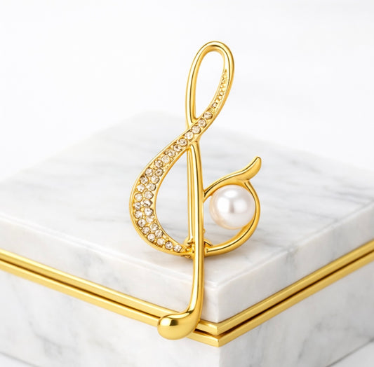 Goldene Notenschlüssel-Brosche mit Perle – Fleur d'Estime