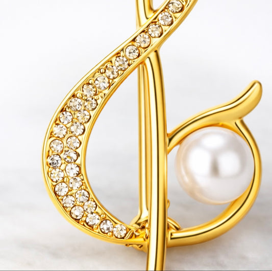 Goldene Notenschlüssel-Brosche mit Perle – Fleur d'Estime